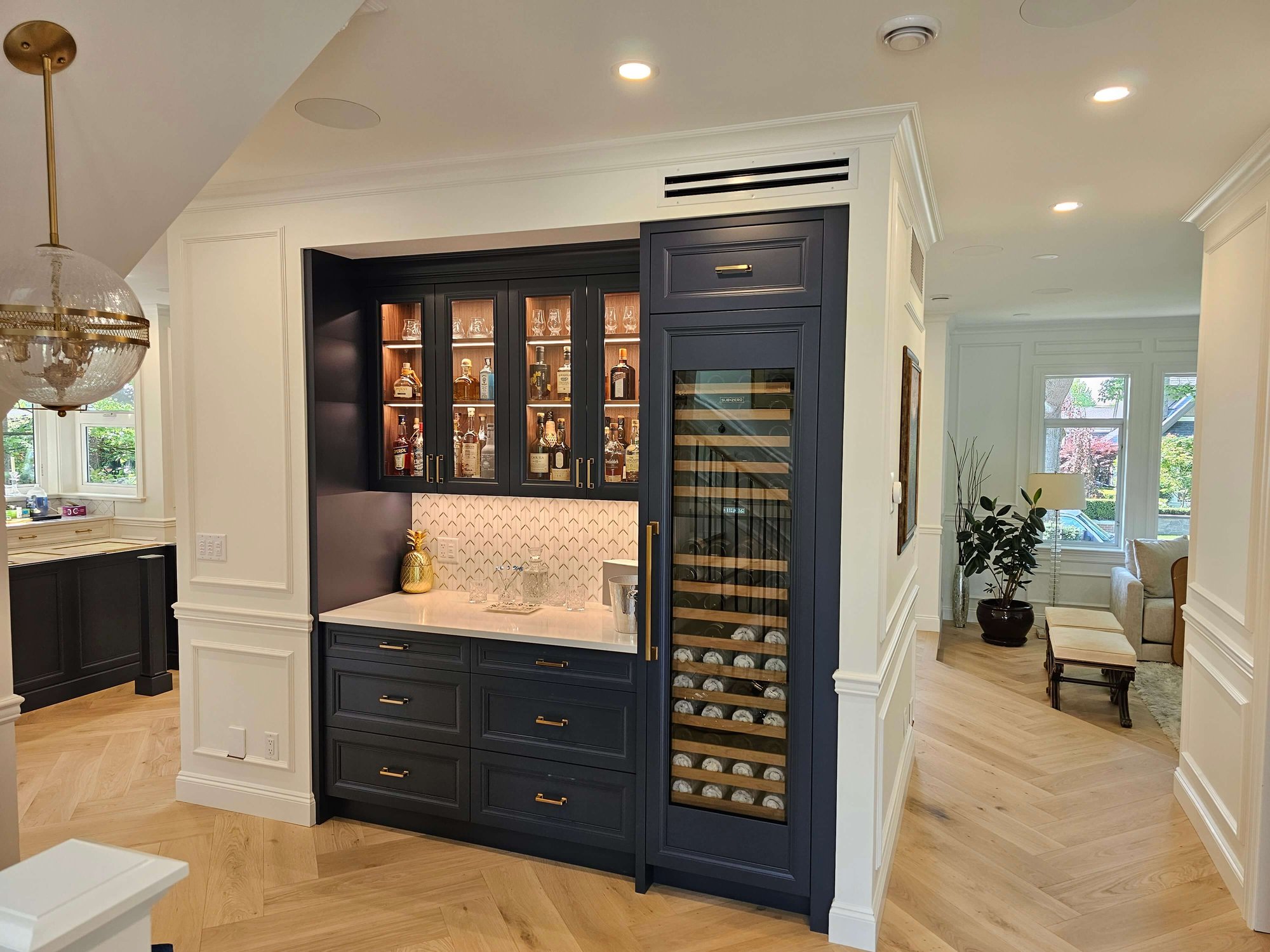 electrician work done for bar area with dark blue cabinets with glass and puck lights